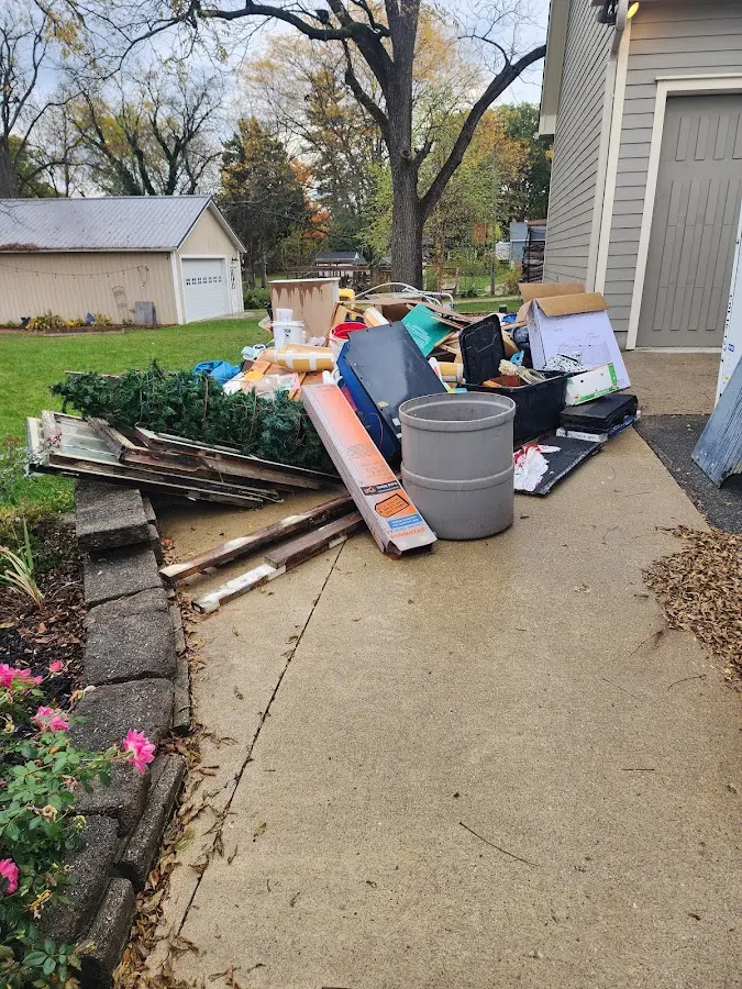 Dumpster being loaded with debris for 12 Yard Dumpster Rental in Huntertown